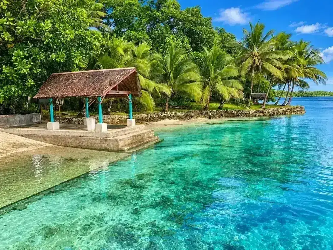 Lagoon waters and tropical pavilion at Freshwater Plantation
